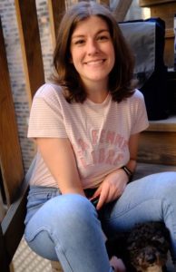 Sara sitting on a stairwell, smiling