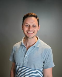 Stephen Lang, Senior Manager on the Banking team, smiling in a blue and white striped shirt